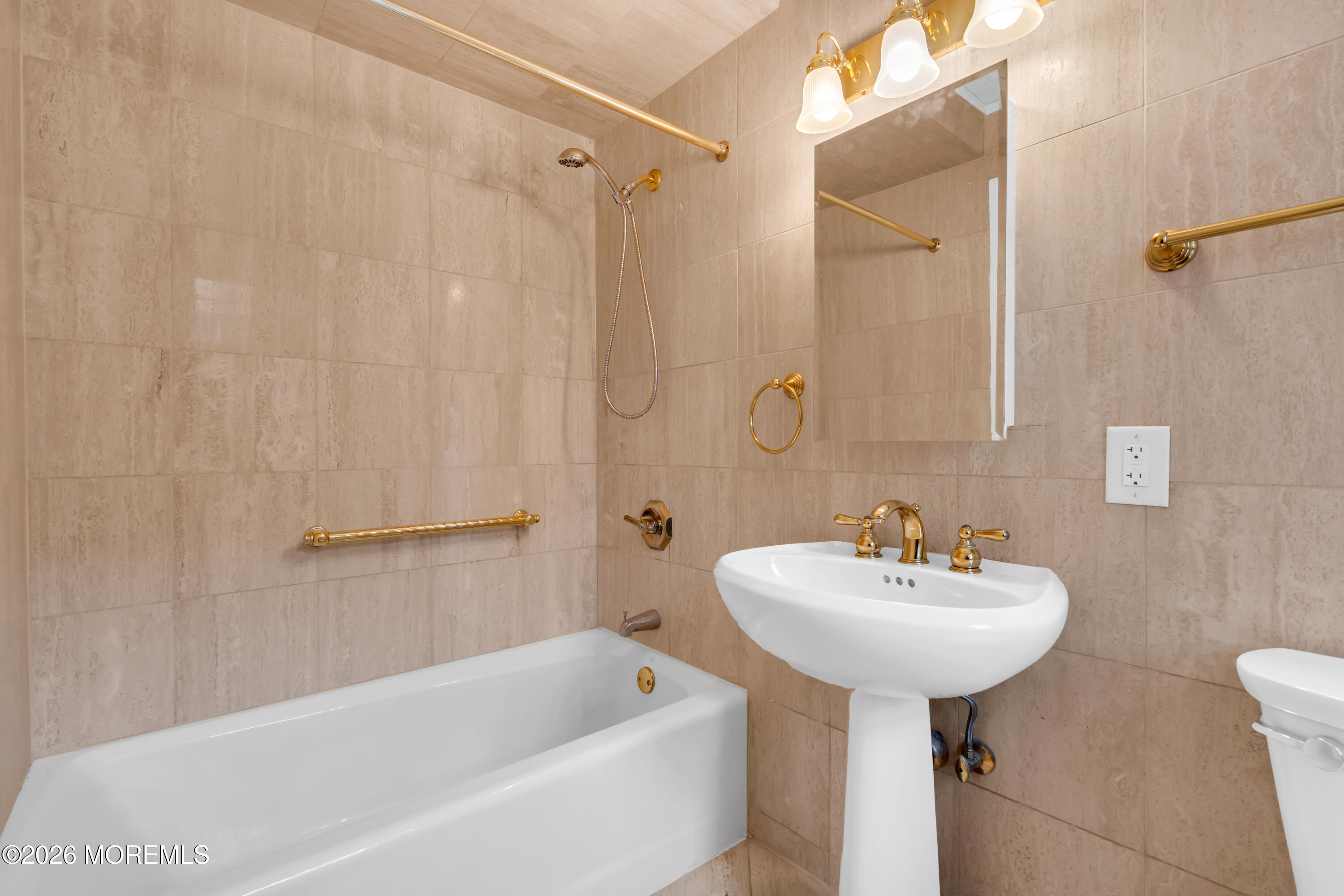 700 Ocean Avenue, Unit G29 Spring Lake, NJ 07762 - Photo 22 of 25 a bathroom with a sink a mirror and a bathtub