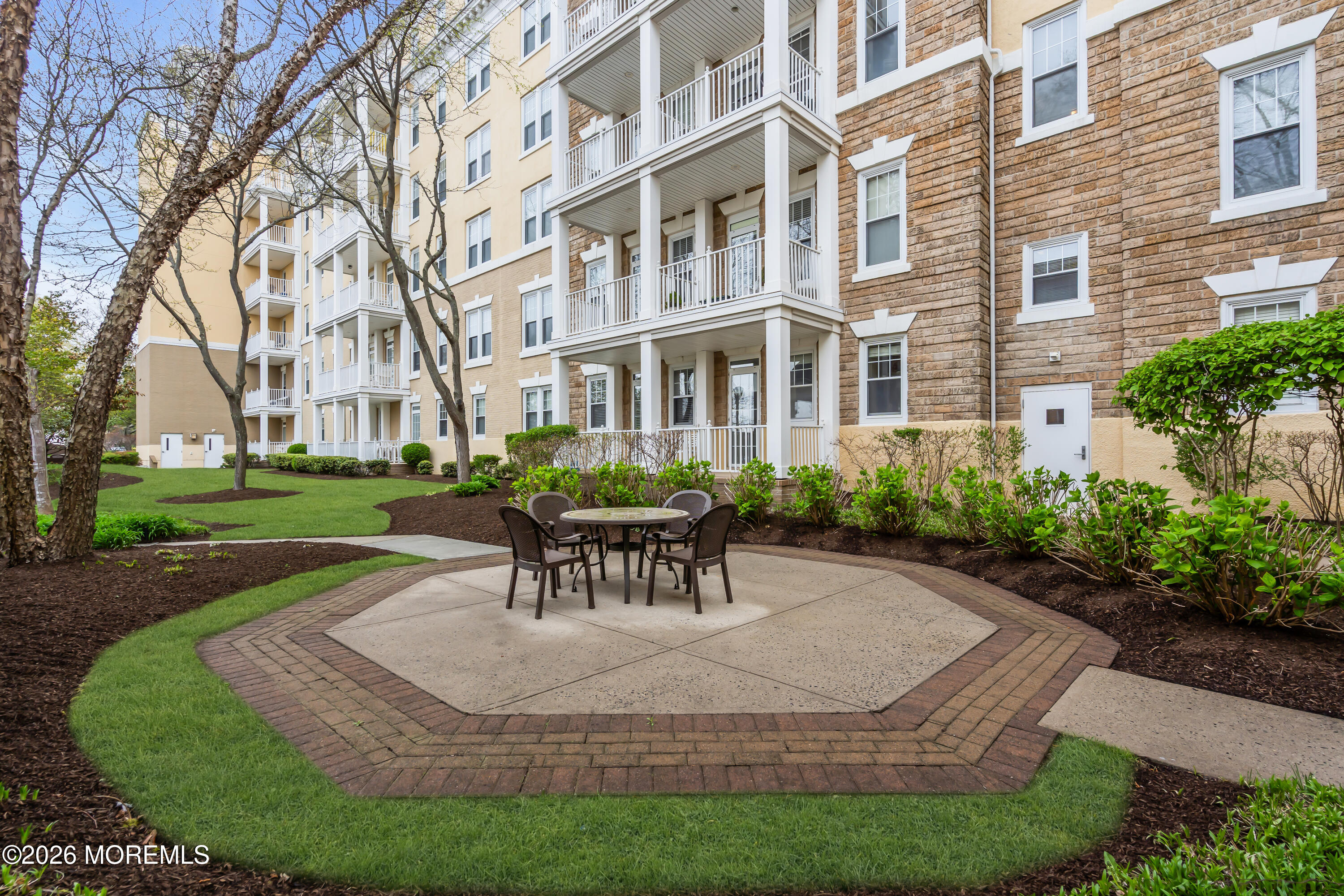700 Ocean Avenue, Unit G29 Spring Lake, NJ 07762 - Photo 3 of 25 a view of a building with garden and sitting area