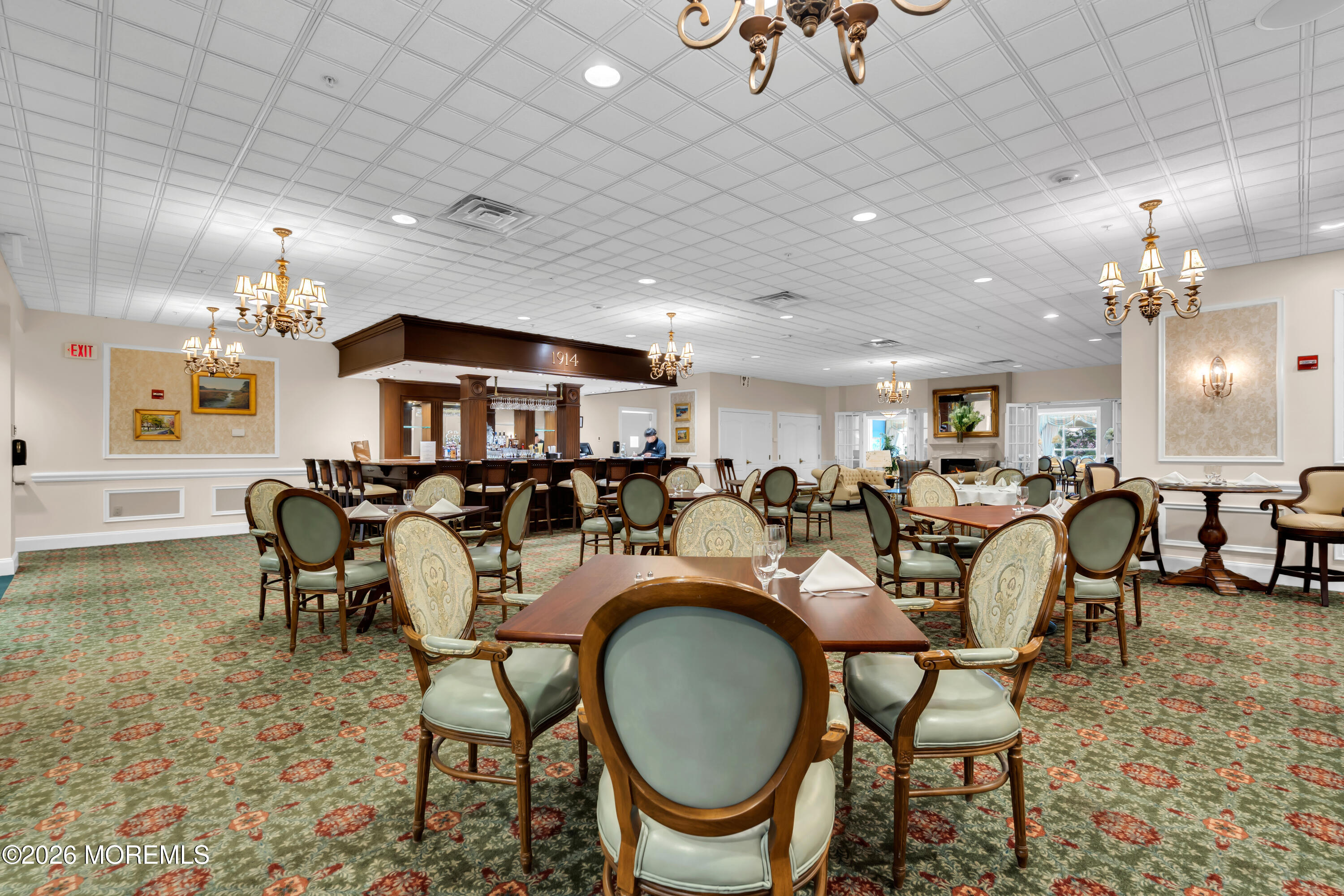 700 Ocean Avenue, Unit G29 Spring Lake, NJ 07762 - Photo 9 of 25 a living room with lots of furniture and a chandelier