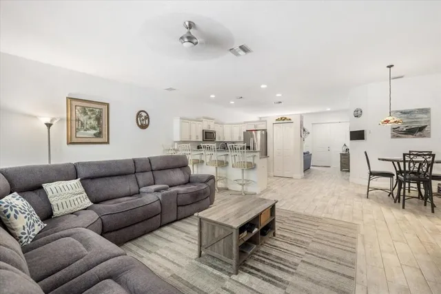 a living room with furniture and view of kitchen