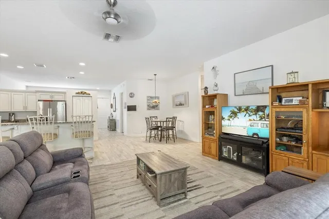 a living room with furniture and a kitchen view