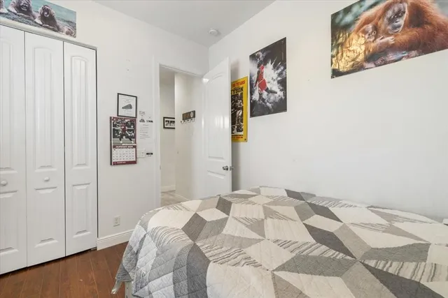 a bedroom with a bed and painting on the wall