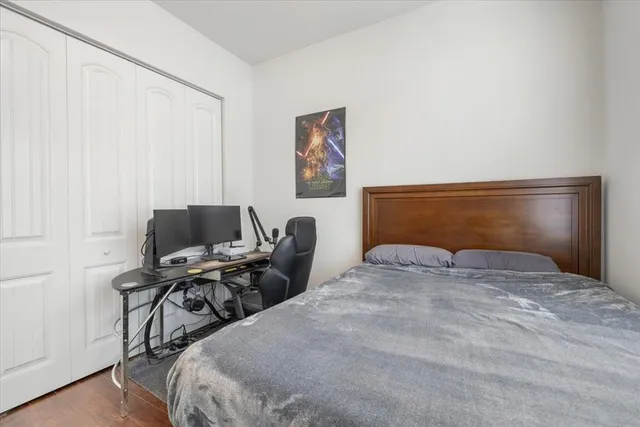 a bedroom with a bed and a chair in it