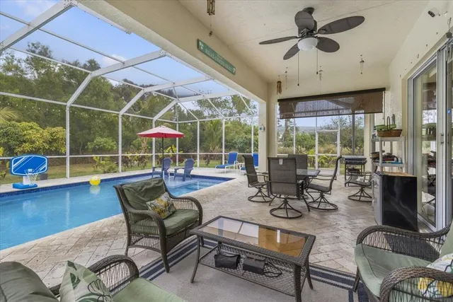 a view of a dining room with furniture wooden floor and chandelier