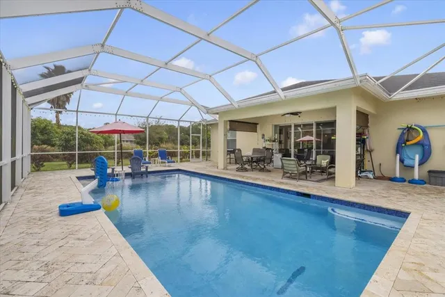 a view of a swimming pool with outdoor seating
