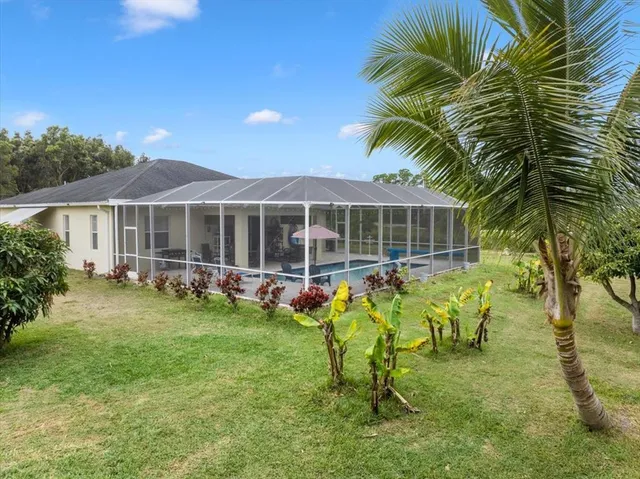 a view of a house with swimming pool and porch with furniture