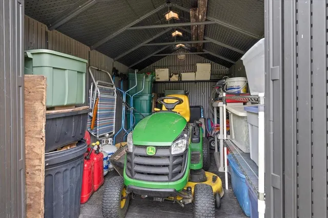 an aerial view of residential houses with outdoor space and trees