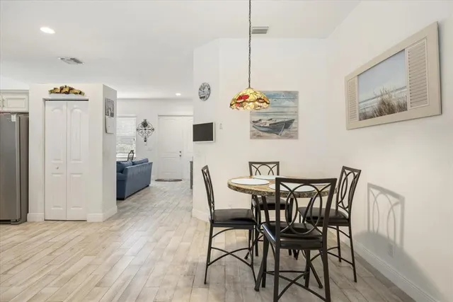 a view of a dining room with furniture and wooden floor