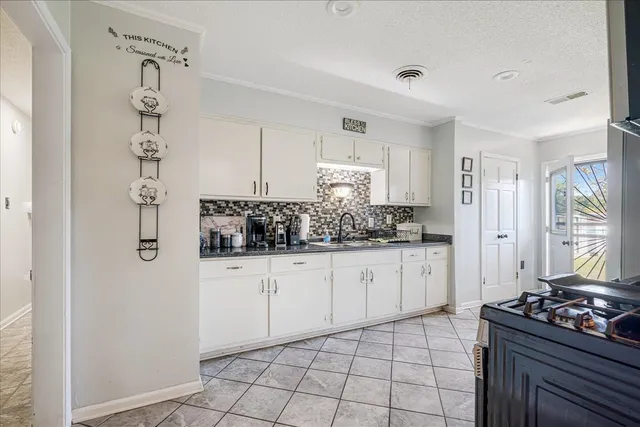 a kitchen with a sink stove and refrigerator