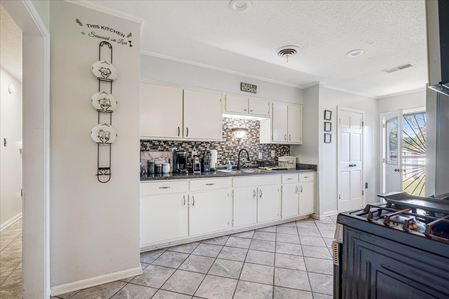 4340 Bluebell Street Memphis, TN 38109 - Photo 13 of 29 a kitchen with a sink stove and refrigerator