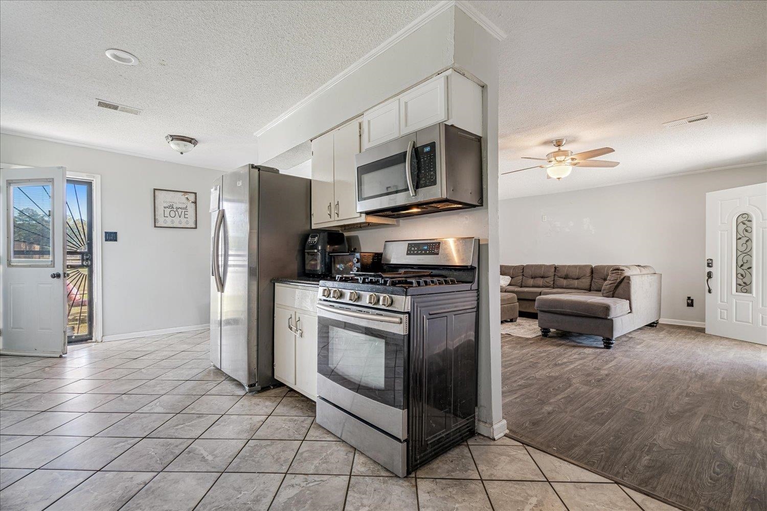 4340 Bluebell Street Memphis, TN 38109 - Photo 29 of 29 a kitchen with stainless steel appliances granite countertop a stove and a refrigerator