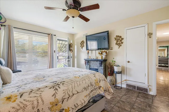 a bedroom with a bed and ceiling fan