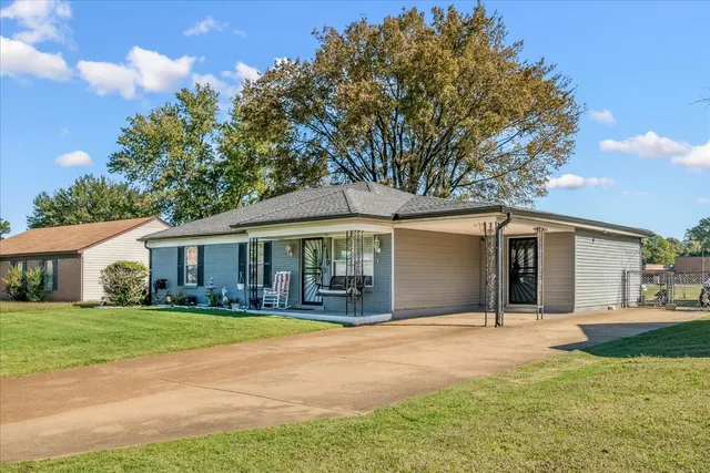 a front view of a house with yard and green space