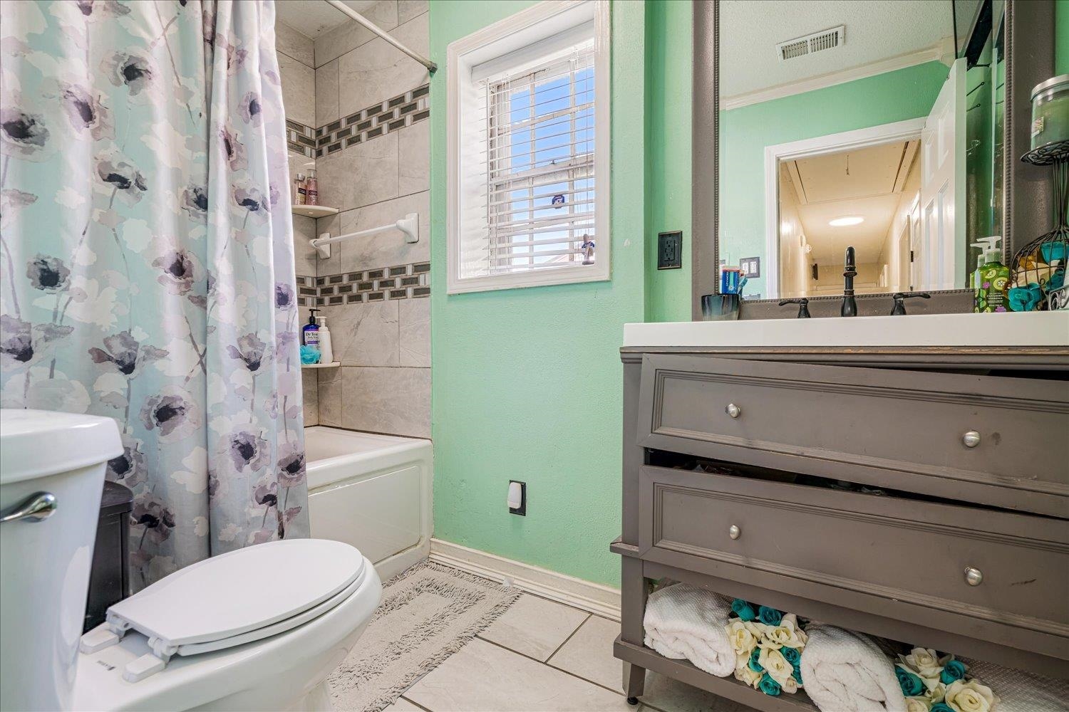4340 Bluebell Street Memphis, TN 38109 - Photo 22 of 29 a bathroom with a toilet a sink and a mirror