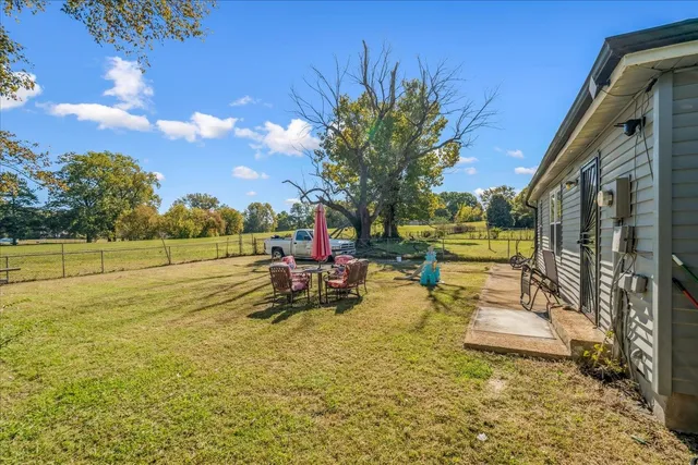 a view of a house with swimming pool and sitting area