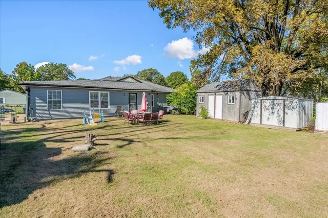 a view of a house with swimming pool and a yard