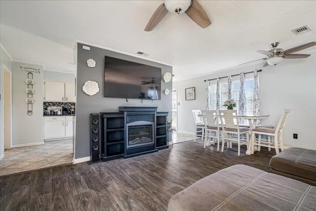 a living room with furniture a fireplace and a flat screen tv