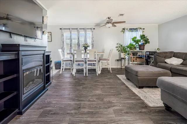a living room with furniture wooden floor and a chandelier