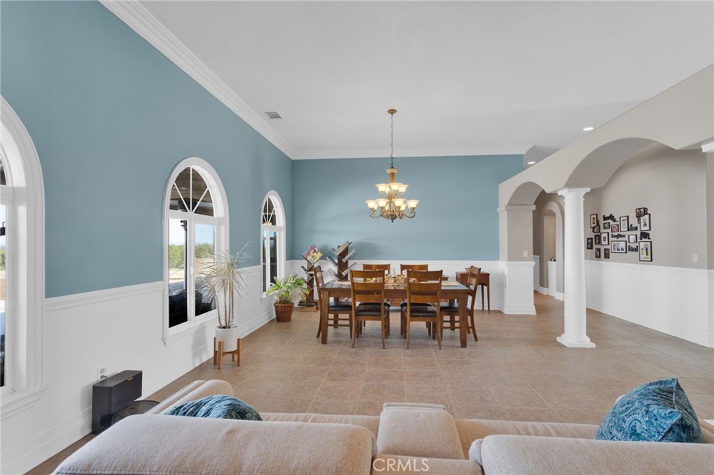 12290 Larch Road Oak Hills, CA 92344 - Photo 11 of 75 a dining room with furniture and a chandelier