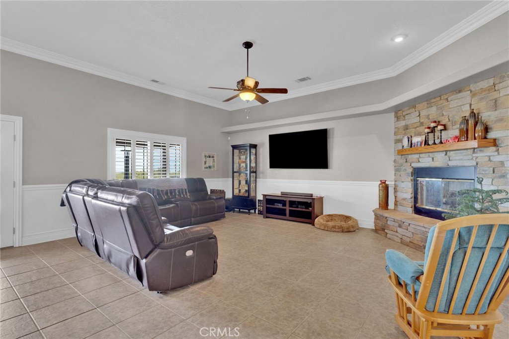 12290 Larch Road Oak Hills, CA 92344 - Photo 17 of 75 a living room with furniture and a flat screen tv