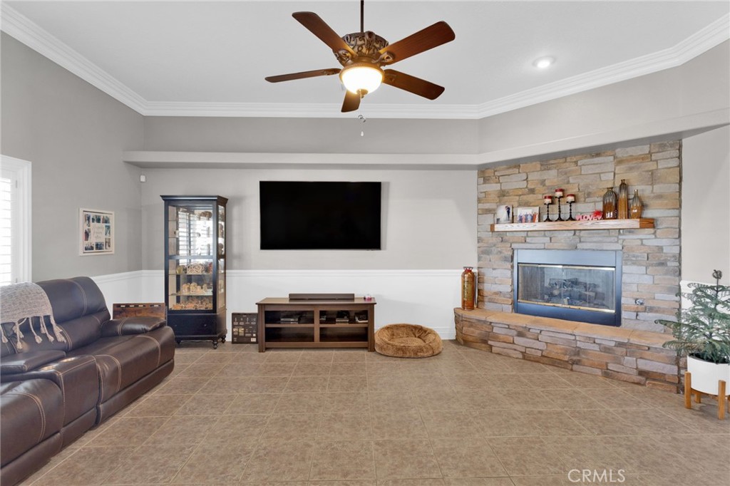 12290 Larch Road Oak Hills, CA 92344 - Photo 18 of 75 a living room with furniture and a flat screen tv