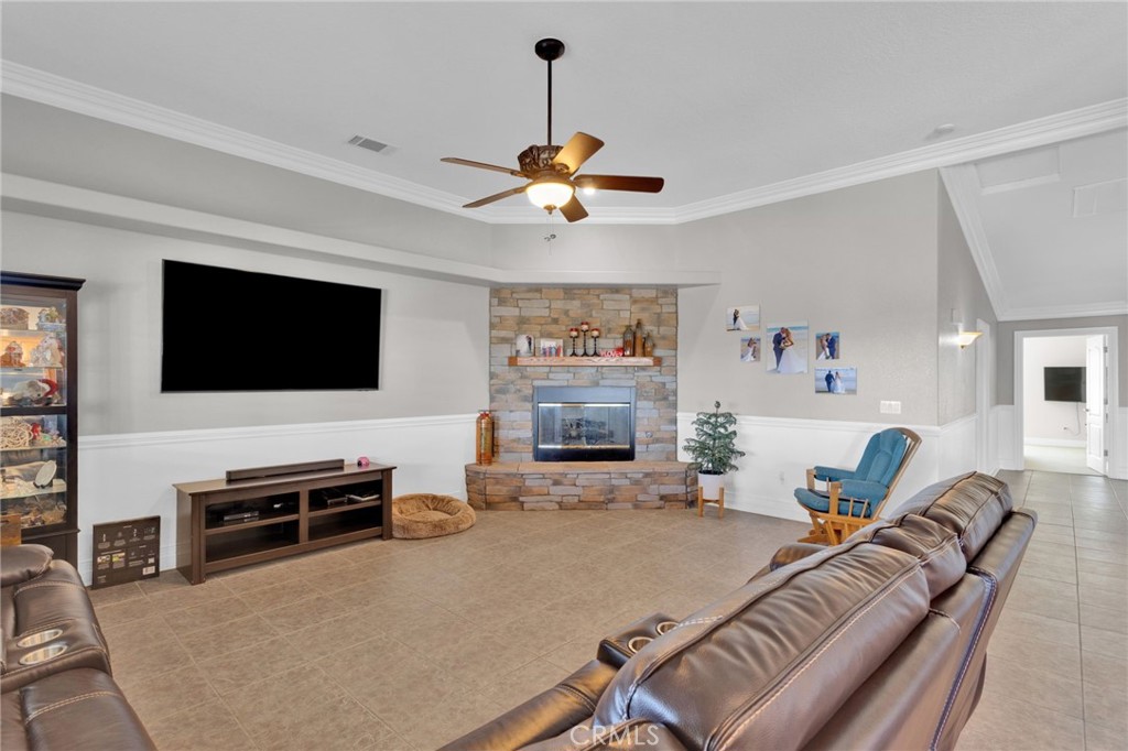 12290 Larch Road Oak Hills, CA 92344 - Photo 19 of 75 a living room with furniture and a flat screen tv