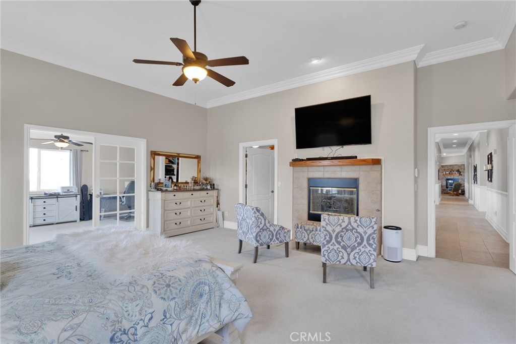 12290 Larch Road Oak Hills, CA 92344 - Photo 28 of 75 a living room with furniture a flat screen tv and a fireplace