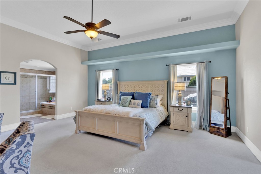 12290 Larch Road Oak Hills, CA 92344 - Photo 29 of 75 a bedroom with a bed and a chandelier