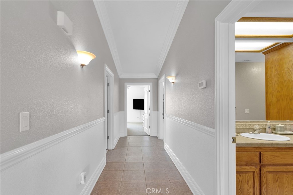 12290 Larch Road Oak Hills, CA 92344 - Photo 38 of 75 a view of a hallway with wooden floor and cabinet