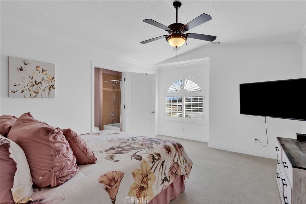 12290 Larch Road Oak Hills, CA 92344 - Photo 39 of 75 a bedroom with a large bed and a flat screen tv