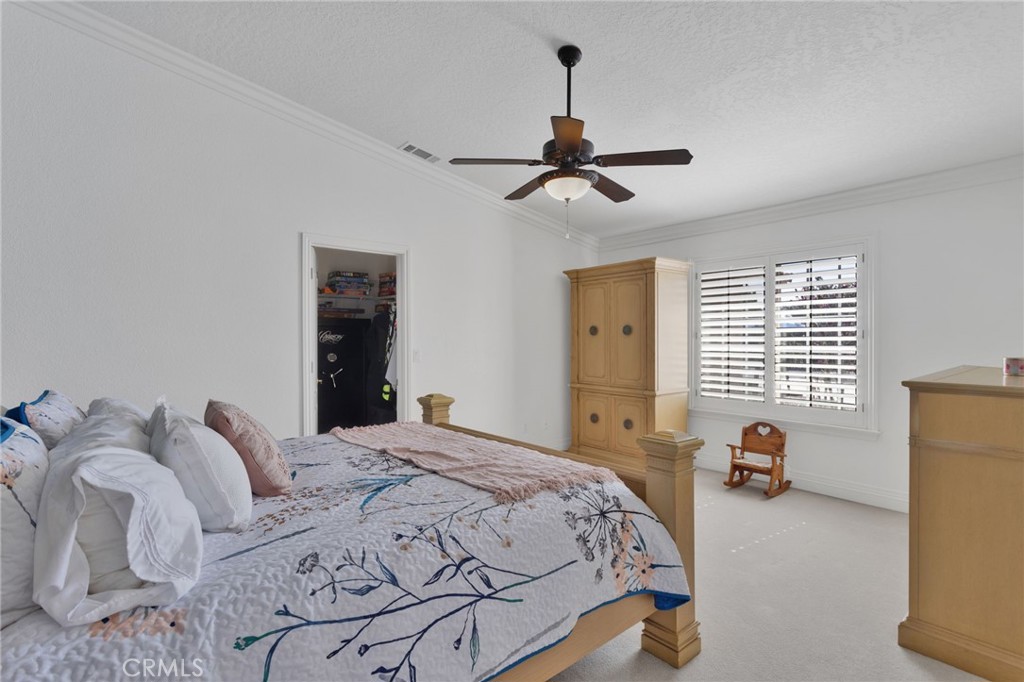 12290 Larch Road Oak Hills, CA 92344 - Photo 48 of 75 a bedroom with a bed and wooden floor