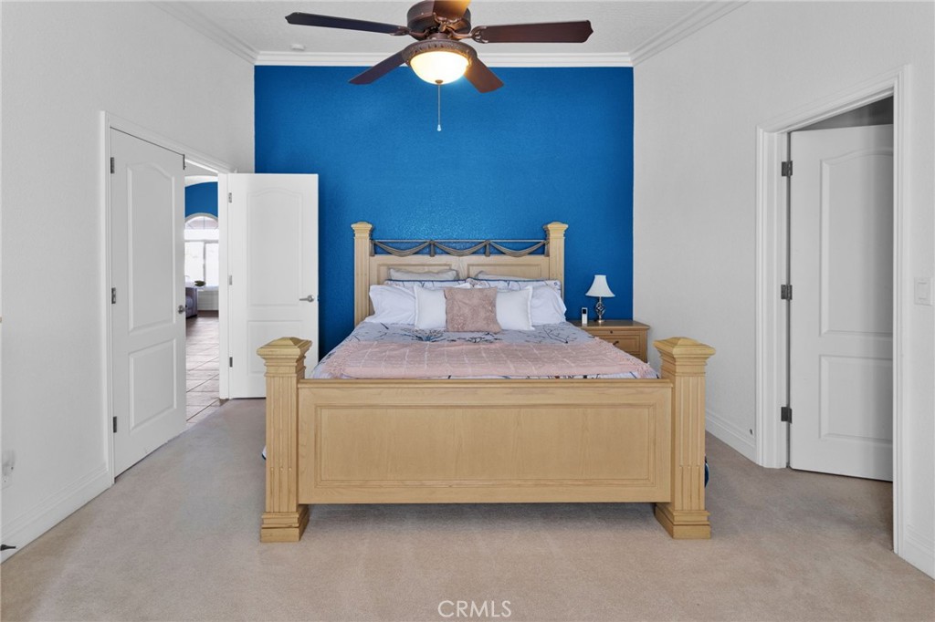 12290 Larch Road Oak Hills, CA 92344 - Photo 49 of 75 a bedroom with a bed and a chandelier