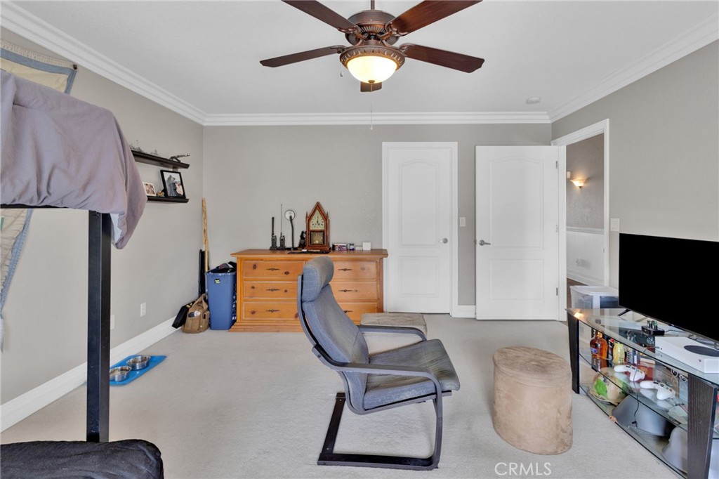 12290 Larch Road Oak Hills, CA 92344 - Photo 52 of 75 a living room with furniture and a flat screen tv