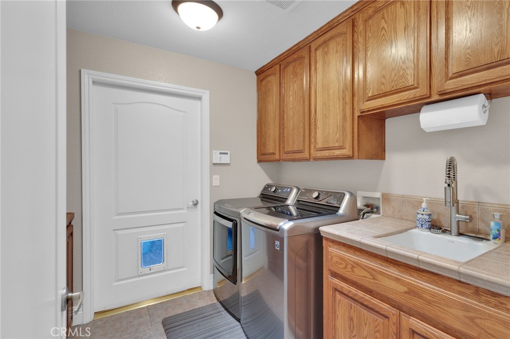 12290 Larch Road Oak Hills, CA 92344 - Photo 54 of 75 a kitchen with stainless steel appliances granite countertop a sink a stove and cabinets