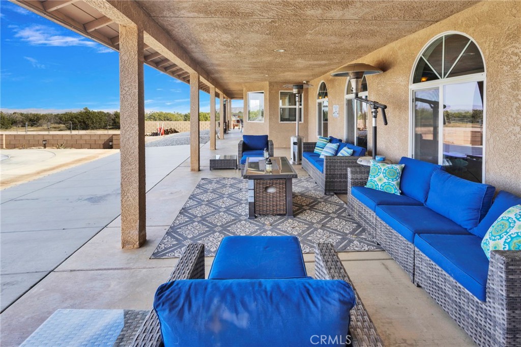 12290 Larch Road Oak Hills, CA 92344 - Photo 55 of 75 a living room with furniture floor to ceiling window and wooden floor