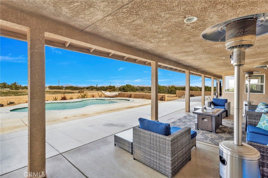 12290 Larch Road Oak Hills, CA 92344 - Photo 56 of 75 a living room with furniture city view and a floor to ceiling window