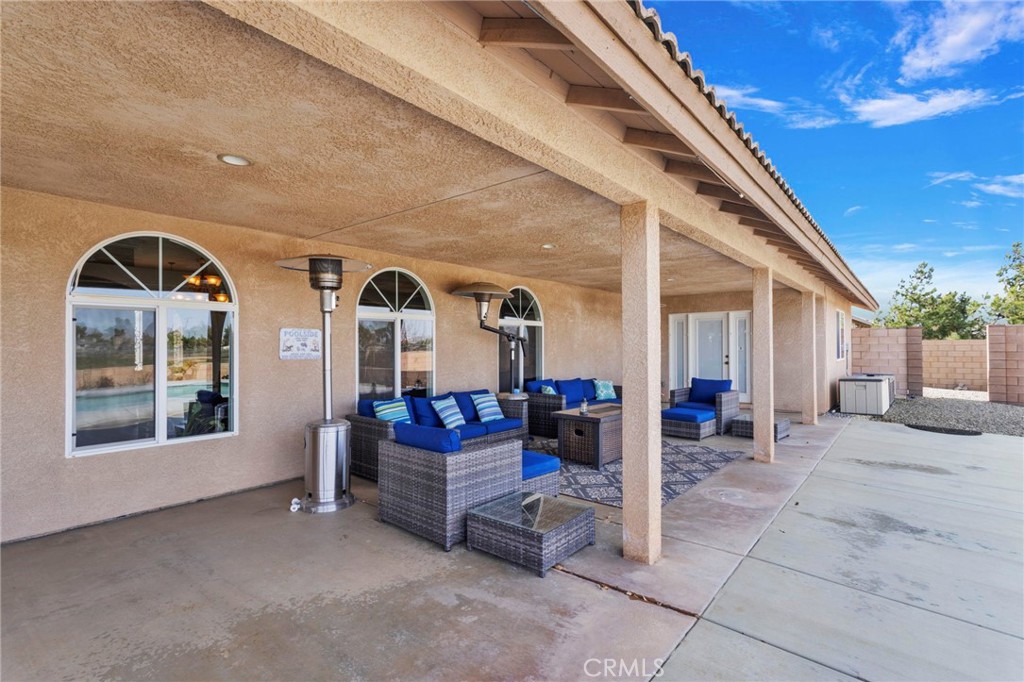 12290 Larch Road Oak Hills, CA 92344 - Photo 60 of 75 a view of living room kitchen with furniture and outdoor seating