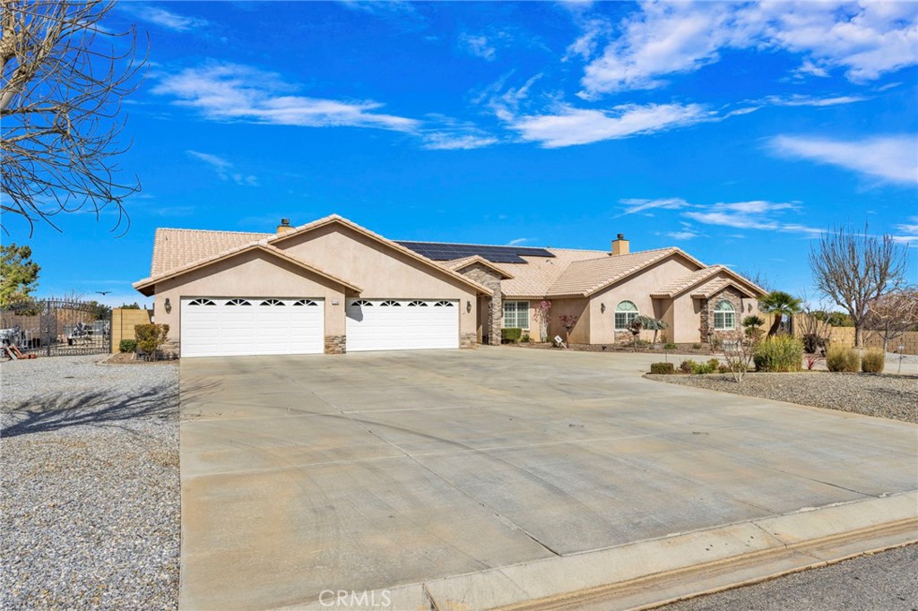12290 Larch Road Oak Hills, CA 92344 - Photo 6 of 75 a front view of a house with a yard and garage