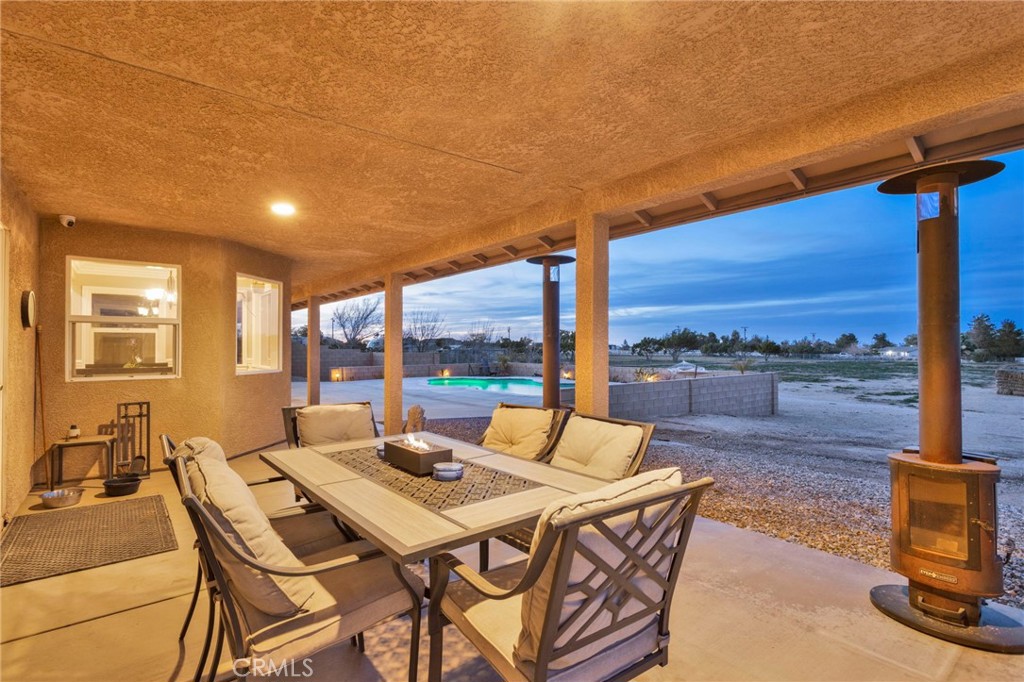 12290 Larch Road Oak Hills, CA 92344 - Photo 72 of 75 a view of a patio with a table and chairs