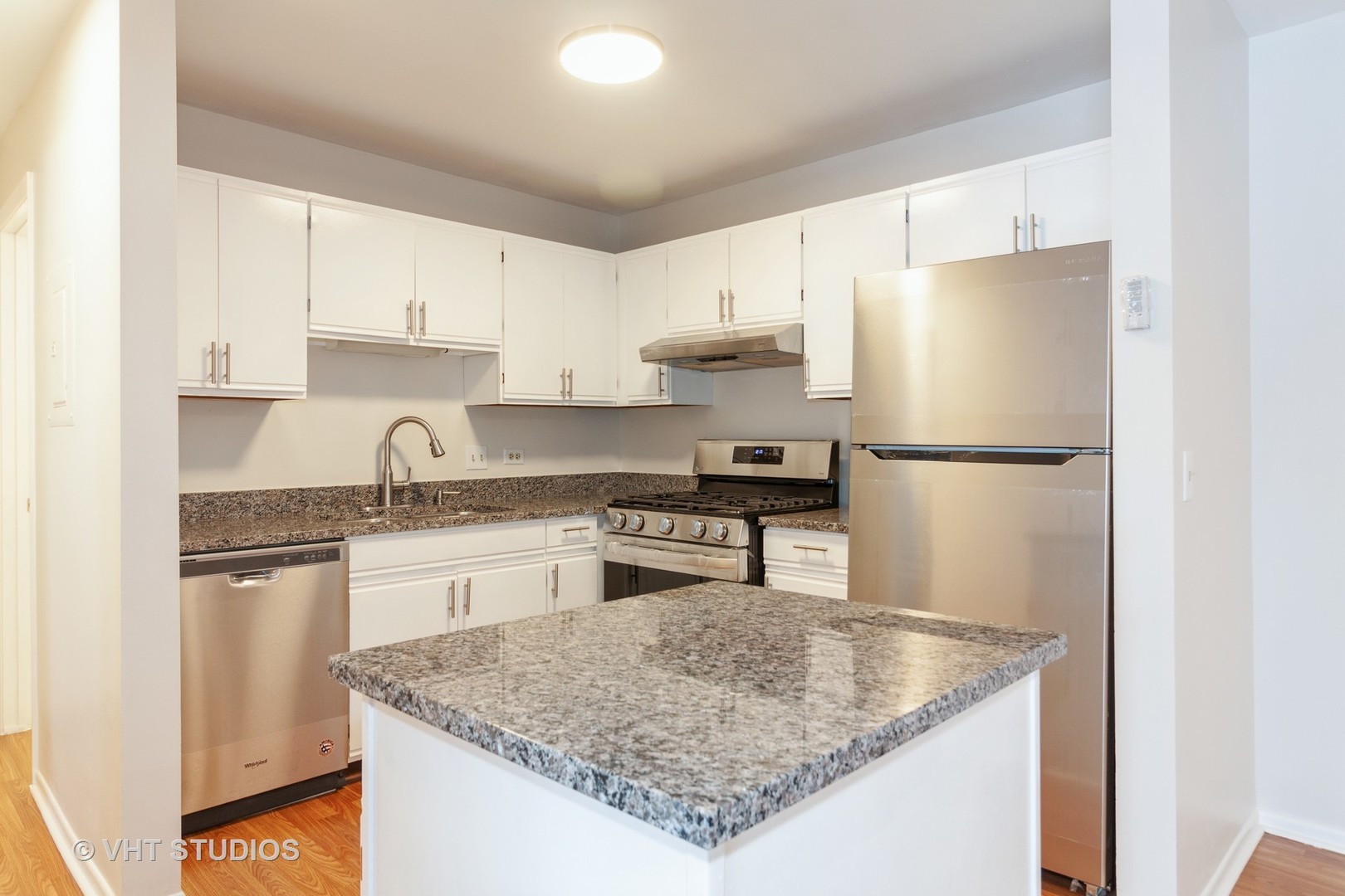 1352 McDowell Road, Unit 103 Naperville, IL 60563 - Photo 2 of 12 a kitchen with stainless steel appliances granite countertop a sink stove and refrigerator