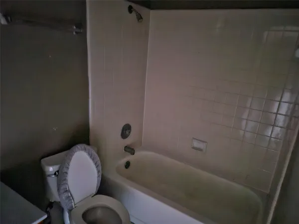 a bathroom with a toilet and bathtub