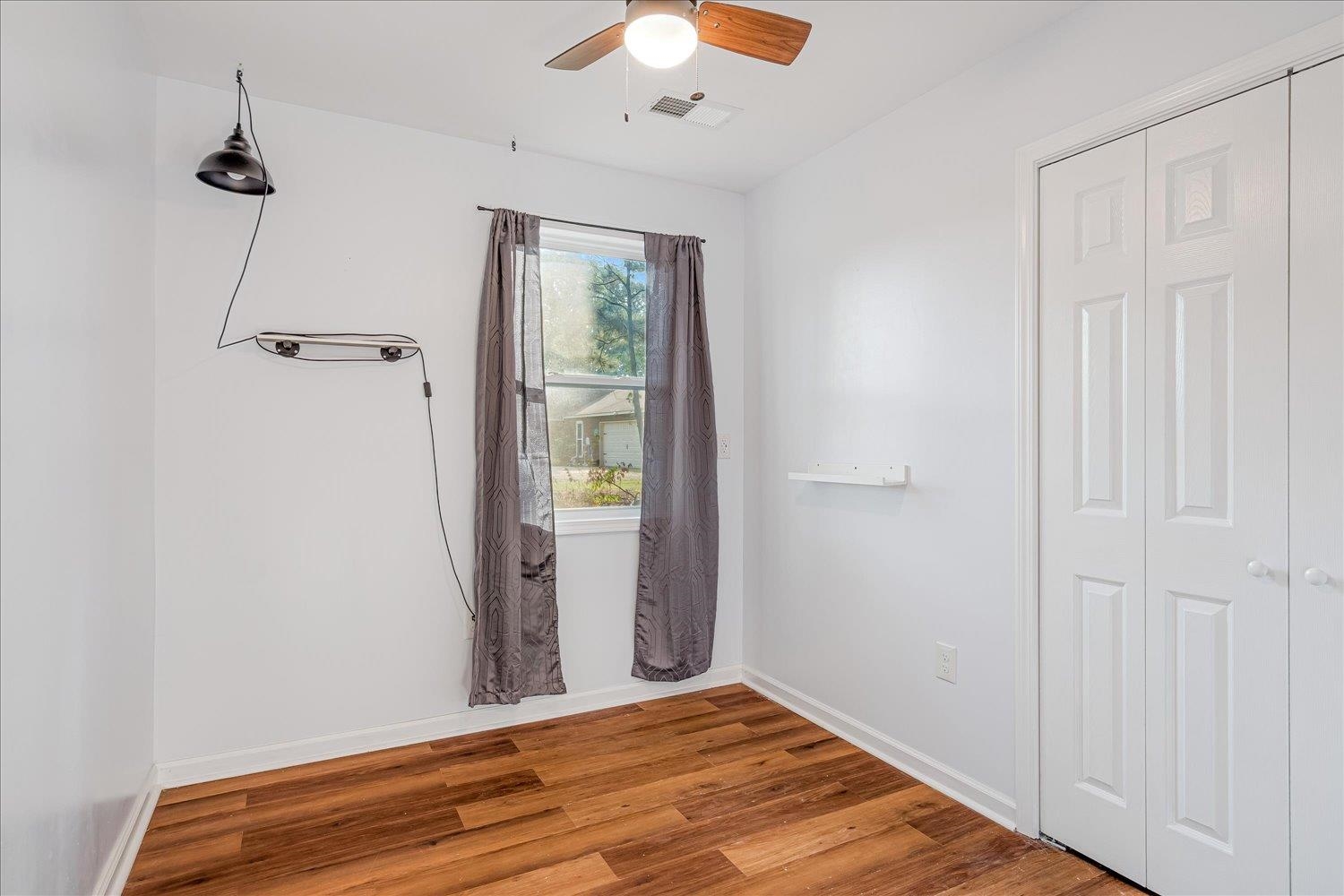 8371 McCalla Road Millington, TN 38053 - Photo 7 of 27 Empty room with wood finished floors and a ceiling fan