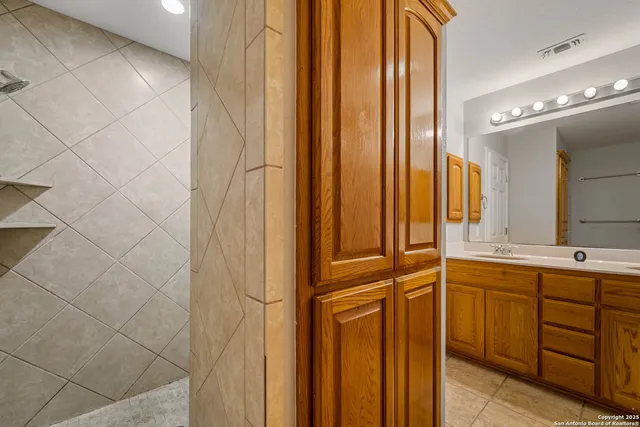 a bathroom with a double vanity sink and a mirror
