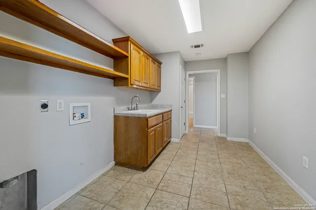 an empty room with windows and ceiling fan