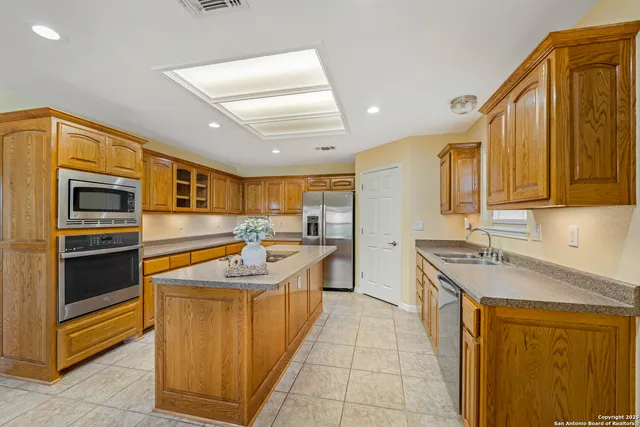 an empty room with windows and fireplace