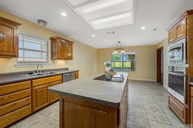 a view of a livingroom with wooden floor and a ceiling fan