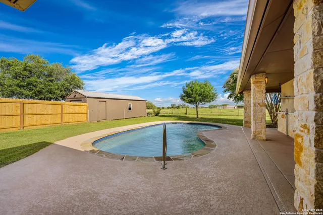 a view of a house with a big yard and large trees