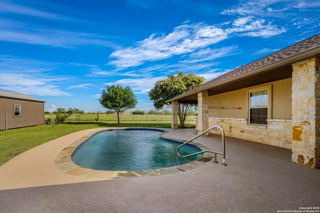 a view of a house with a backyard