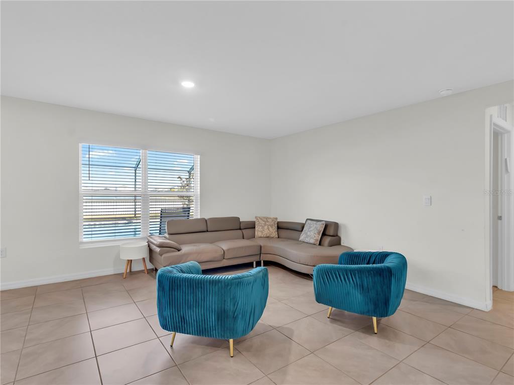 5446 Logan Cave Avenue Wimauma, FL 33598 - Photo 17 of 57 a living room with furniture and a window