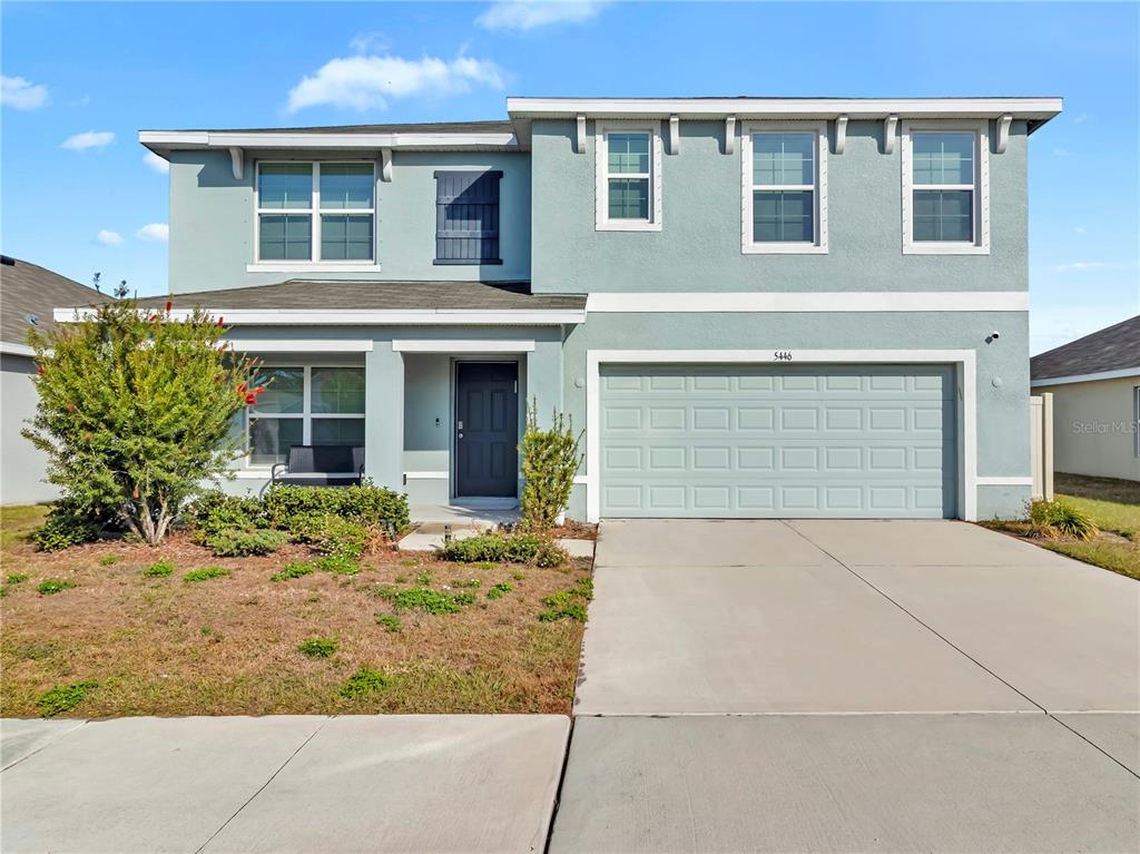 5446 Logan Cave Avenue Wimauma, FL 33598 - Photo 2 of 57 a front view of a house with garden